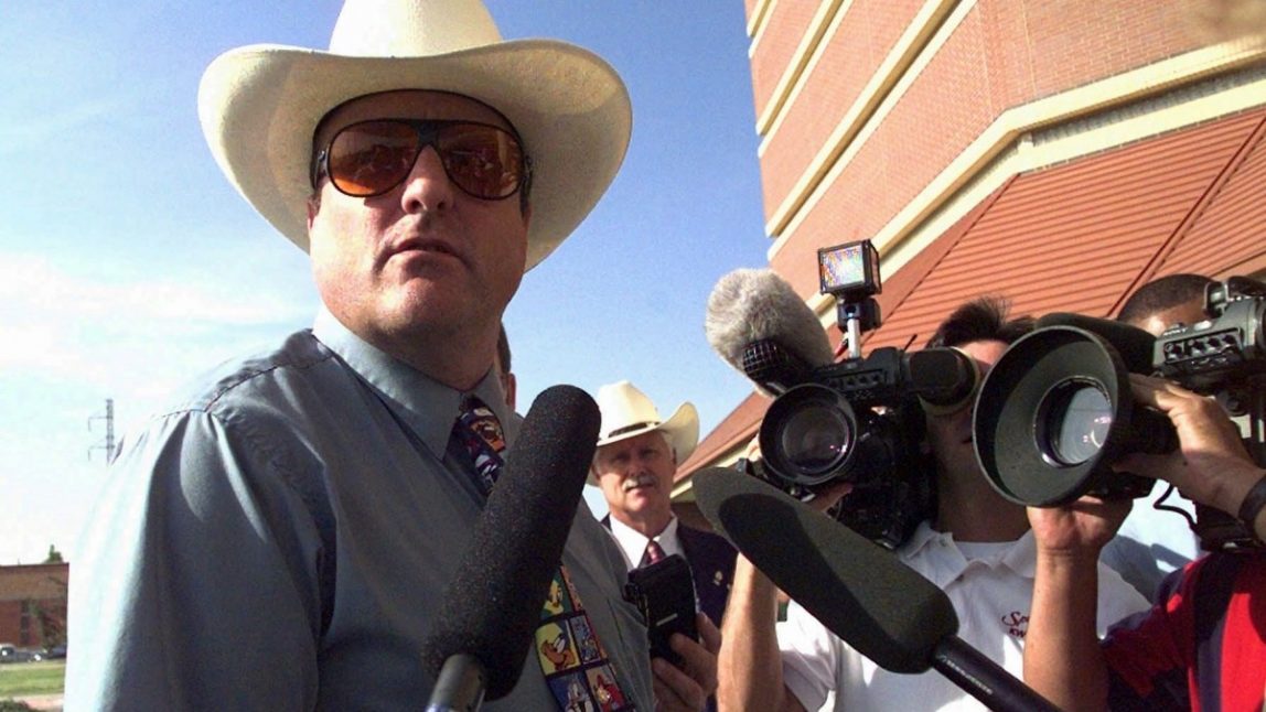 FILE - In this July 16, 1997 file photo, Dennis Mahon, a white supremacist from Tulsa, Okla., talks to the media in Oklahoma City, Ok., before appearing before an Oklahoma County grand jury investigating the Oklahoma City bombing. Closing arguments began Tuesday morning, Feb. 21, 2012 in a federal trial in Arizona, where Mahon and his brother Don stand accused of bombing a Scottsdale city official. (AP Photo/J. Pat Carter, File)