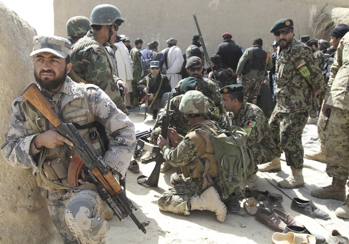 Afghan security forces are seen after Taliban militants opened fire on delegation of senior Afghan officials in Panjwai, Kandahar province south of Kabul, Afghanistan, Tuesday, March. 13, 2012. (AP Photo/Allauddin Khan)