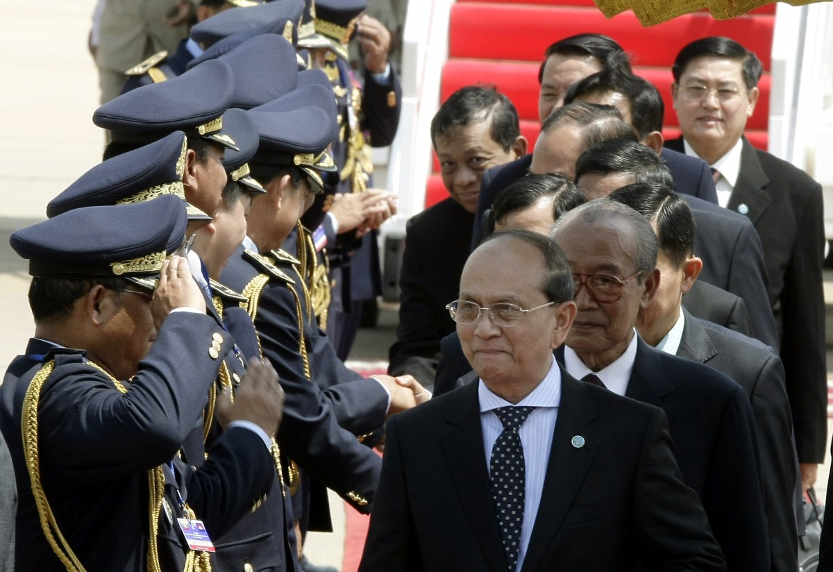 Myanmar president U Thein Sein, center, walks upon his arrival at Phnom Penh International Airport in Phnom Penh, Cambodia, Wednesday, March 21, 2012. U Thein Sein on Wednesday arrived Phnom Penh during his pays two days state visit to Cambodia, on March 21-22, 2012. (Heng Sinith)