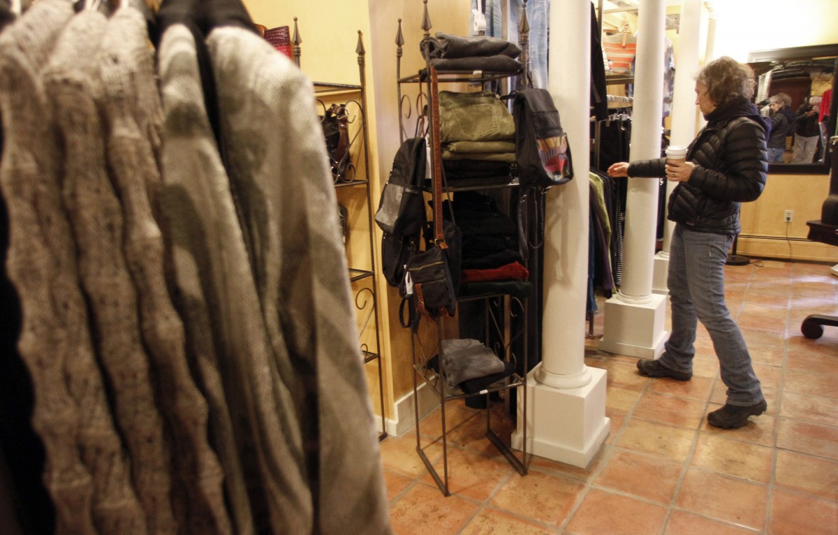 FILE - In this Feb. 28, 2012 file photo, Laurie Hanson looks over clothing at the Adorn clothing store in Montpelier, Vt. U.S. consumers boosted their spending in February by the most in seven months. But Americans' income barely grew, and the saving rate fell to its lowest point in more than two years, according to the Commerce Department, Friday, March 30, 2012. (AP Photo/Toby Talbot, File)