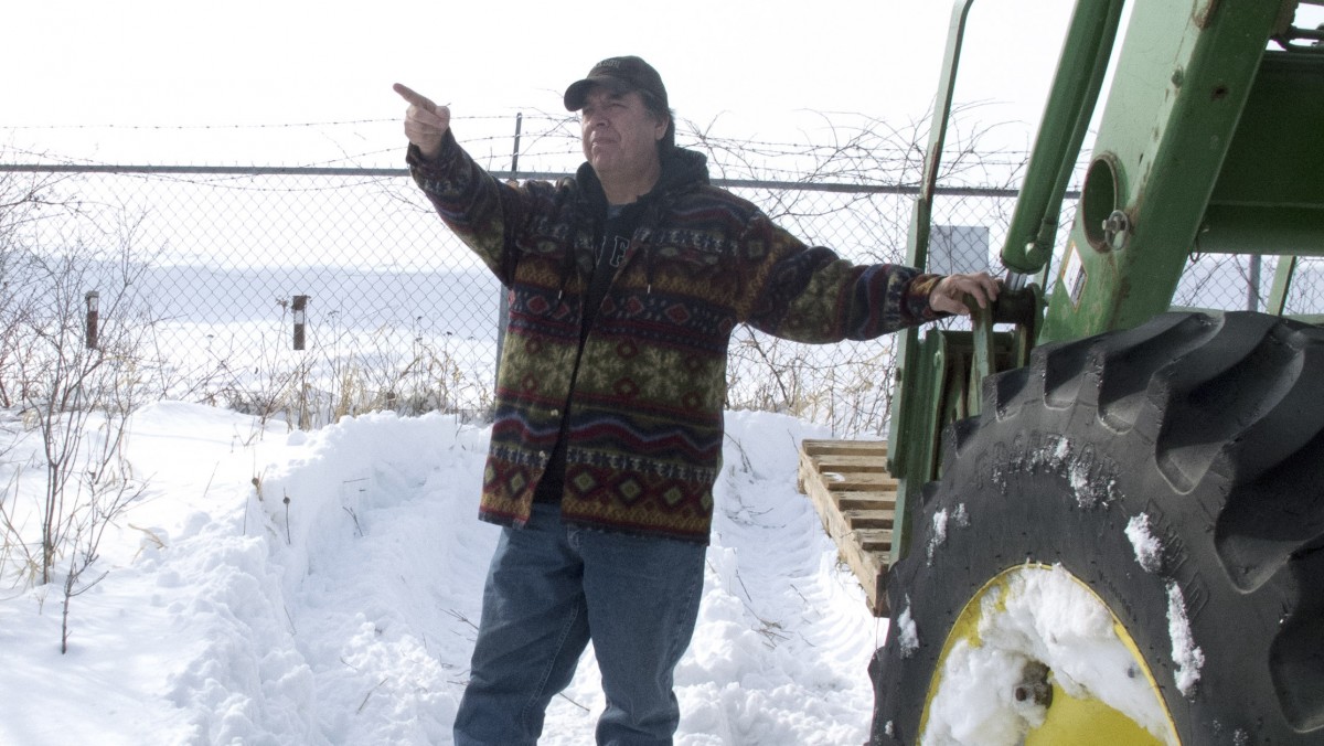 Larry Thompson stands on his familyâs land at Raquette Point on the Mohawksâ Akwesasne Reservation in northern New York, near the chain-link fence that separates it from the former General Motors landfill, in Massena, N.Y., on Tuesday, Feb. 28, 2012. Residents of the Akwesasne reservation are not satisfied with Superfund cleanup plans that would leave the PCB-contaminated landfill in place, capped. (AP Photo/Michael Virtanen)