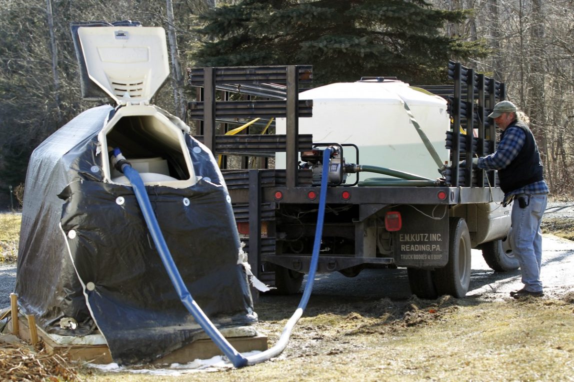 In a Monday, Feb. 13, 2012 photo, Ray Kemble pumps water from a truck into his neighbor's tank in Dimock, Pa. The U.S. Environmental Protection Agency appears to be ramping up its interest in the Marcellus Shale a rock formation in Pennsylvania and surrounding states that is believed to hold the nations largest reservoir of gas with investigations in both the northeastern and southwestern corners of Pennsylvania. The drilling industry accuses EPA of overreach. (AP Photo/Matt Rourke)