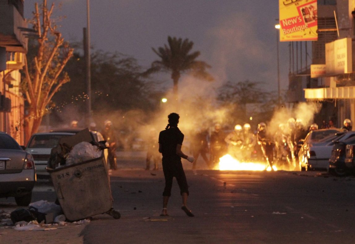 Riot police fire tear gas as Molotov cocktails land at their feet during clashes with Bahraini anti-government protesters Tuesday, March 13, 2012, in Diraz, Bahrain. (AP Photo/Hasan Jamali)