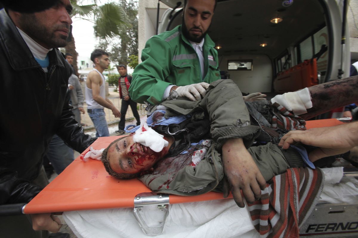 Palestinian medics wheel a wounded man to the treatment room of Shifa hospital following an Israeli air strike in Gaza City, Monday, March 12, 2012. Israeli airstrikes killed two Palestinians and a schoolboy in the Gaza Strip on Monday and Palestinian rocket squads barraged southern Israel, in escalating fighting that has defied international truce efforts. (AP Photo/Yasser Qudih)