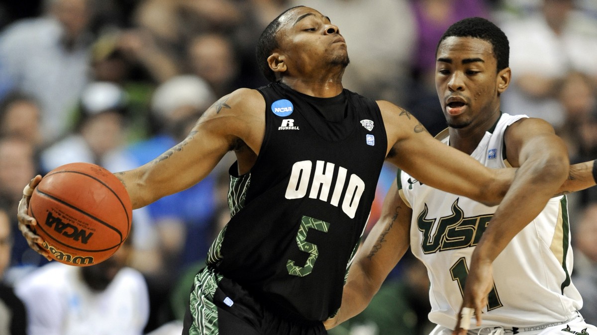 Ohio guard D.J. Cooper (5) gets tangled with South Florida guard Anthony Collins (11) in the first half of a third-round NCAA men's college basketball tournament game Sunday, March 18, 2012, in Nashville, Tenn. (AP Photo/Donn Jones)