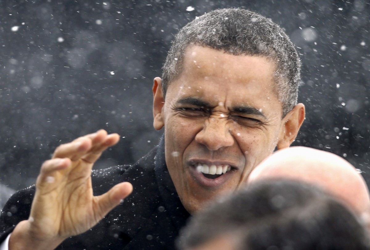 President Barack Obama waves to the crowd as he walks through a snowstorm after getting of Air Force One in Manchester, N.H. ,Thursday, March 1, 2012, on his way to speak at the Nashua (N.H.) Community College. (AP Photo/Winslow Townson)