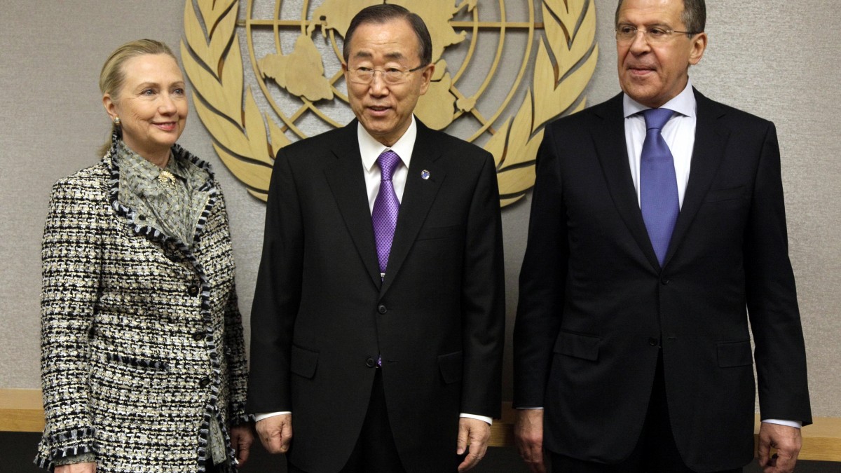 U.S. Secretary of State Hillary Rodham Clinton, and Russian Foreign Minister Sergei Lavrov flank U.N. Secretary-General Ban Ki-moon, center, who gestures to a video screen, during a photo session at the beginning of the beginning of their meeting at United Nations headquarters, Monday, March 12, 2012. The bloody conflict in Syria is likely to dominate public and private talks Monday as key ministers meet at the United Nations on the Israeli-Palestinian conflict and challenges from the Arab Spring. (AP Photo/Richard Drew)
