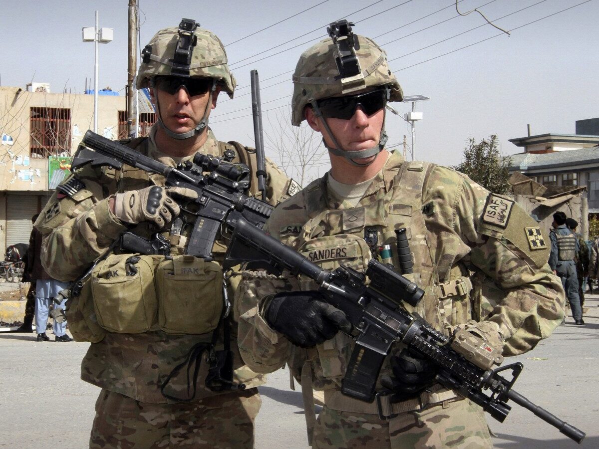 In this Feb. 5, 2012 file photo, U.S. soldiers part of the NATO- led International Security Assistace Force (ISAF) are seen alert at the scene of a suicide attack in Kandahar, south of Kabul, Afghanistan. (AP Photo/Allauddin Khan, File)