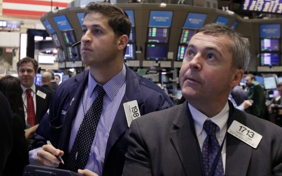 In this Feb. 28, 2012 photo, traders Thomas Donato, center, and James Lamb work on the floor of the New York Stock Exchange, March 26, 2012. (AP Photo/Richard Drew)