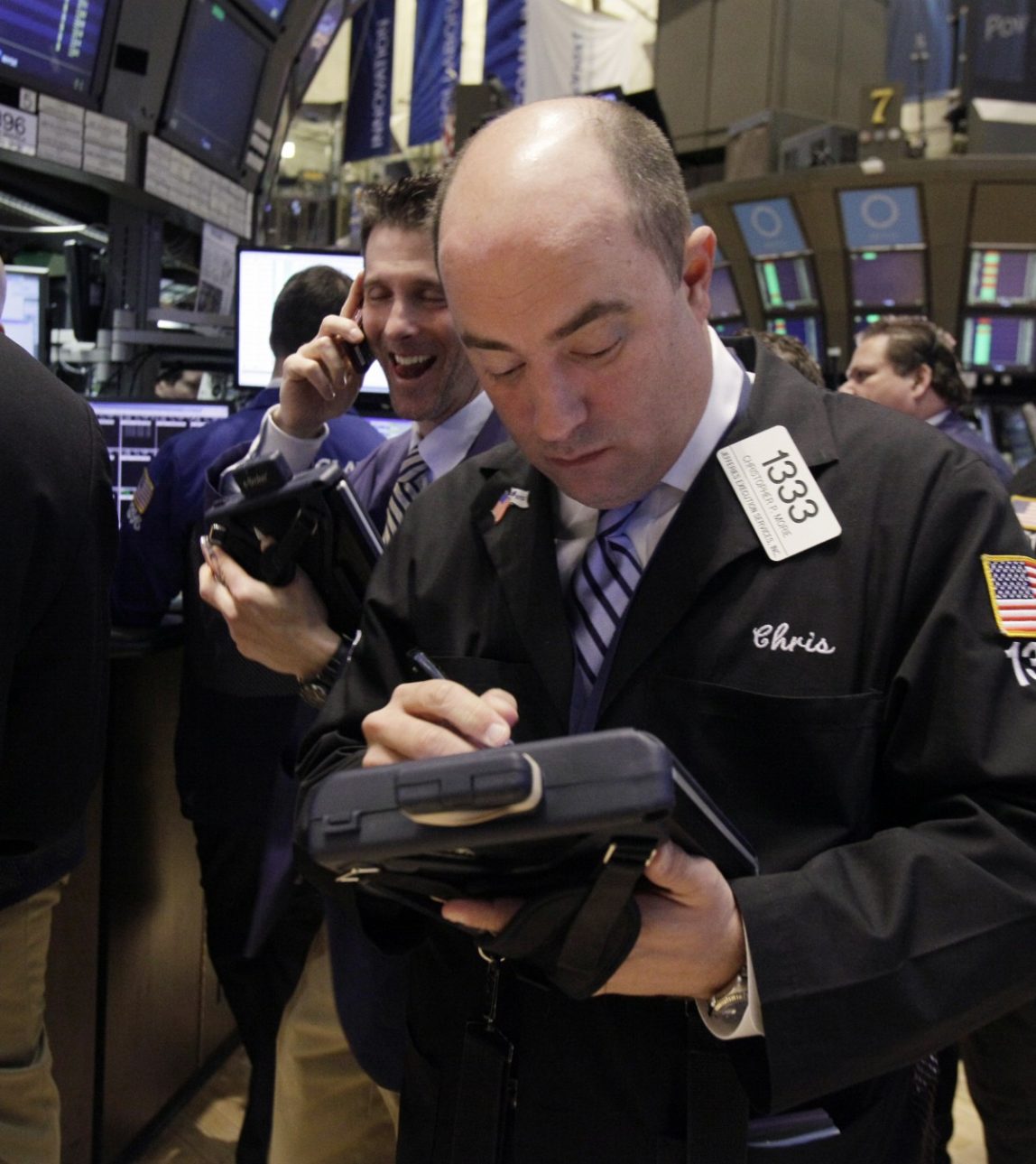 In a Tuesday March 13, 2012 photo Trader Christopher Morie, right, works on the floor of the New York Stock Exchange. (AP Photo/Richard Drew)