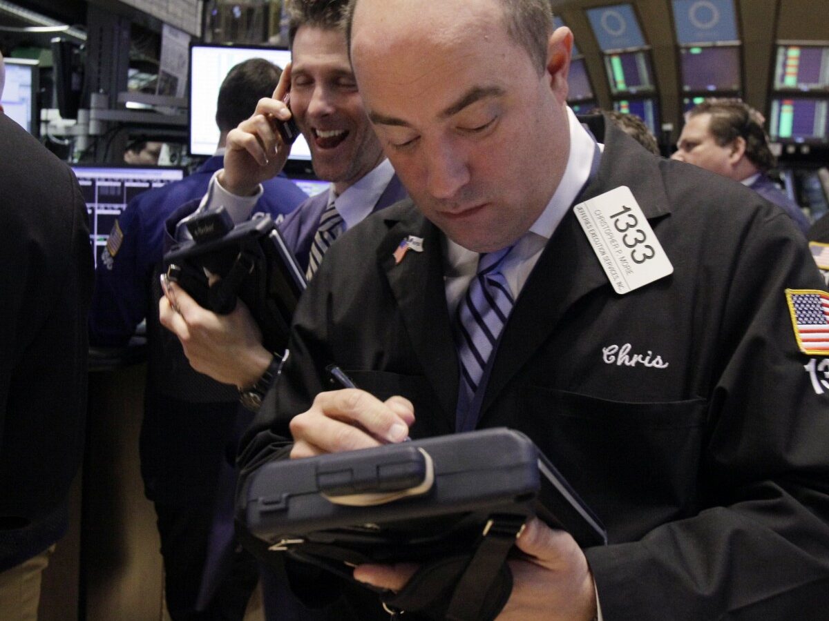 In a Tuesday March 13, 2012 photo Trader Christopher Morie, right, works on the floor of the New York Stock Exchange. (AP Photo/Richard Drew)