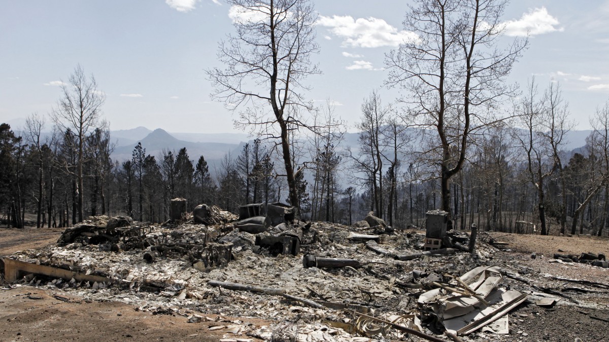 The ruins of a home destroyed by a wildfire are pictured near Conifer, Colo., on Wednesday, March 28, 2012. Two people died in the wildfire that started Monday afternoon. (AP Photo/Ed Andrieski)