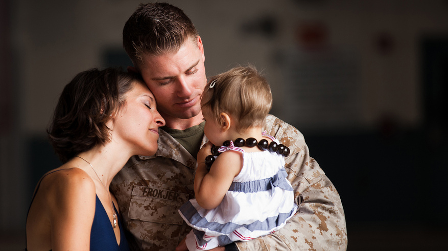 Capt. Lucas Frokjer, officer in charge of the flightline for Marine Heavy Helicopter Squadron 463, reunites with his family after returning from a seven-month deployment with HMH-463.
