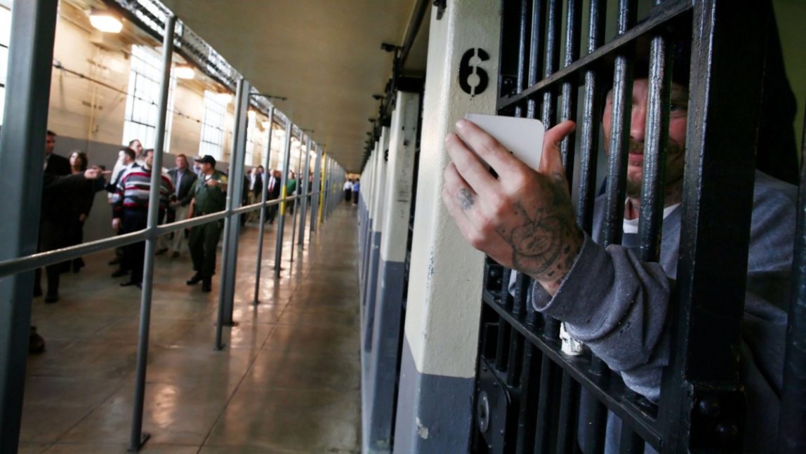 A prison inmate uses his mirror to look at down the hall at a meeting taking place with prison officials and Republican lawmakers. (AP Photo/Brian Baer, Pool)