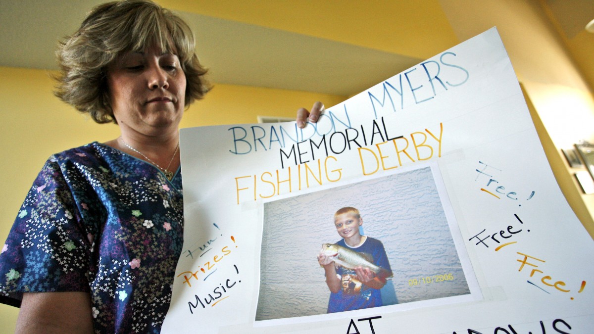 Kim Myers holds a poster used to promote a memorial fishing derby in honor of her son, Brandon, who killed himself in February of 2007, in Lee's Summit, Mo. For Kim Myers, Brandon's death is the result of what she calls incessant bullying that his teachers and other administrators at Voy Spears Elementary School failed to stop. (AP Photo/Ed Zurga)