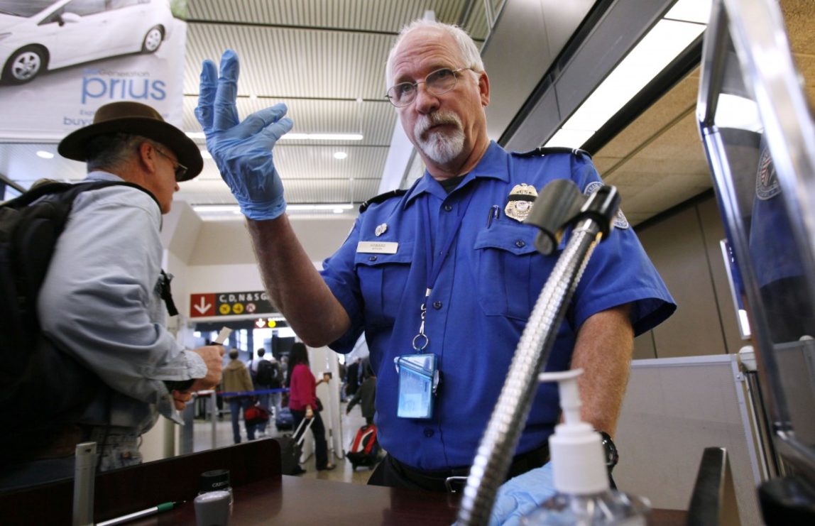 TSA officer Robert Howard signals an airline passenger forward at a security check-point at Seattle-Tacoma International Airport, Monday, Jan. 4, 2010 (AP Photo/Elaine Thompson)