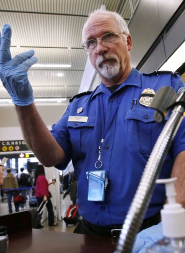 TSA officer Robert Howard signals an airline passenger forward at a security check-point at Seattle-Tacoma International Airport, Monday, Jan. 4, 2010 (AP Photo/Elaine Thompson)