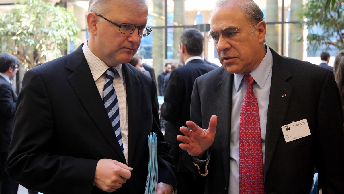 Angel Gurria, the head of the Paris-based international development body OECD, right, talks with European Commissioner for Economic and Monetary Affairs Olli Rehn prior to a media conference, in Brussels, Tuesday, March 27, 2012. The 17 countries that use the euro should boost their crisis firewalls to at least euro 1 trillion (U.S. dollars 1.3 trillion) to help the struggling currency union return to growth, the head of the Organization for Economic Cooperation and Development said Tuesday. (AP Photo/Yves Logghe)
