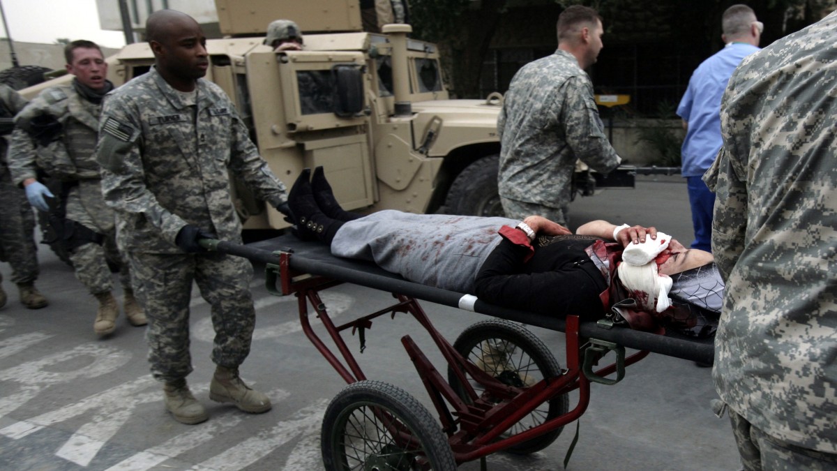 In this Saturday, Dec. 16, 2007 photo, U.S. Army medical staff rush an Iraqi woman who was shot in the face by U.S. troops in an "escalation of force" incident, to the emergency room at Ibn Sina Hospital in the Green Zone in Baghdad, Iraq. (AP Photo/Maya Alleruzzo)