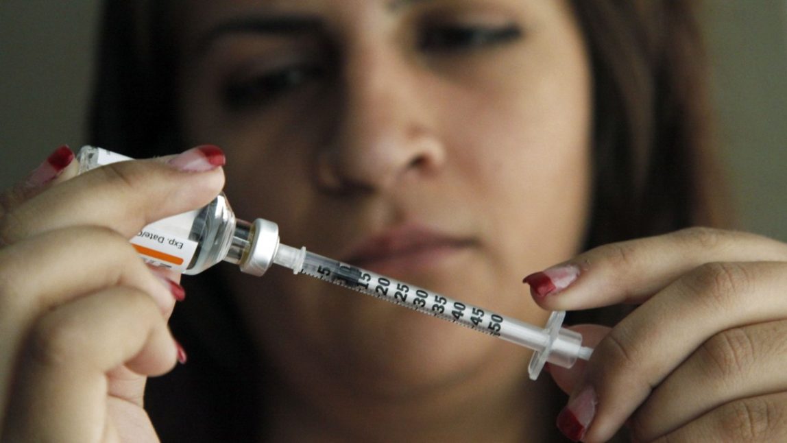 A syringe gets filled in preparation for an injection, Sunday, April 29, 2012. (AP Photo/Reed Saxon)