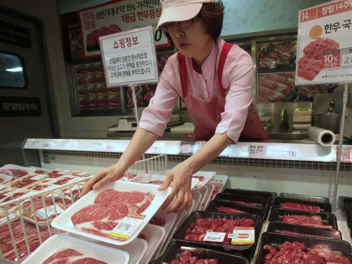 A South Korean employee sets out packs of domestic beef on the shelves at a store on the shelves at a store in Seoul, South Korea, Wednesday, April 25, 2012. Two major South Korean retailers suspended sales of U.S. beef Wednesday following the discovery of mad cow disease in a U.S. dairy cow. Reaction elsewhere in Asia was muted with Japan saying there's no reason to restrict imports. The letters on a card at left top read " Starting from the 25th, we will temporarily stop the sales of the US beef. Thank you for your understanding". (AP Photo/Ahn Young-joon)