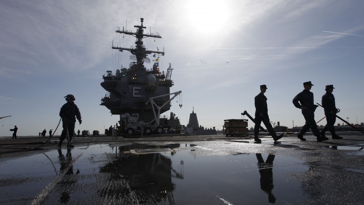 In this March 8, 2012 file photo, sailors clean the flight deck as they move supplies and equipment in preparation for the final deployment of the nuclear aircraft carrier USS Enterprise at the Norfolk Naval Station in Norfolk, Va. The U.S. Navy said Monday, April 9, 2012 that it has deployed a second aircraft carrier to the Persian Gulf region amid rising tensions with Iran over its nuclear program. (AP Photo/Steve Helber, File)