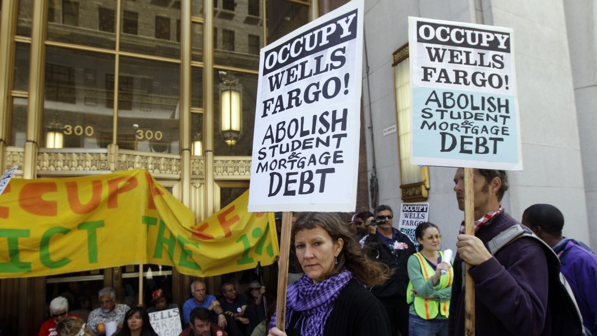 Demonstrators march and block a side entrance to the Wells Fargo shareholders meeting in San Francisco, Tuesday, April 24, 2012. Police guarded the entrance to the annual meeting of Wells Fargo shareholders on Tuesday as protesters associated with the Occupy Wall Street movement protested the gathering. (AP Photo/Marcio Jose Sanchez)