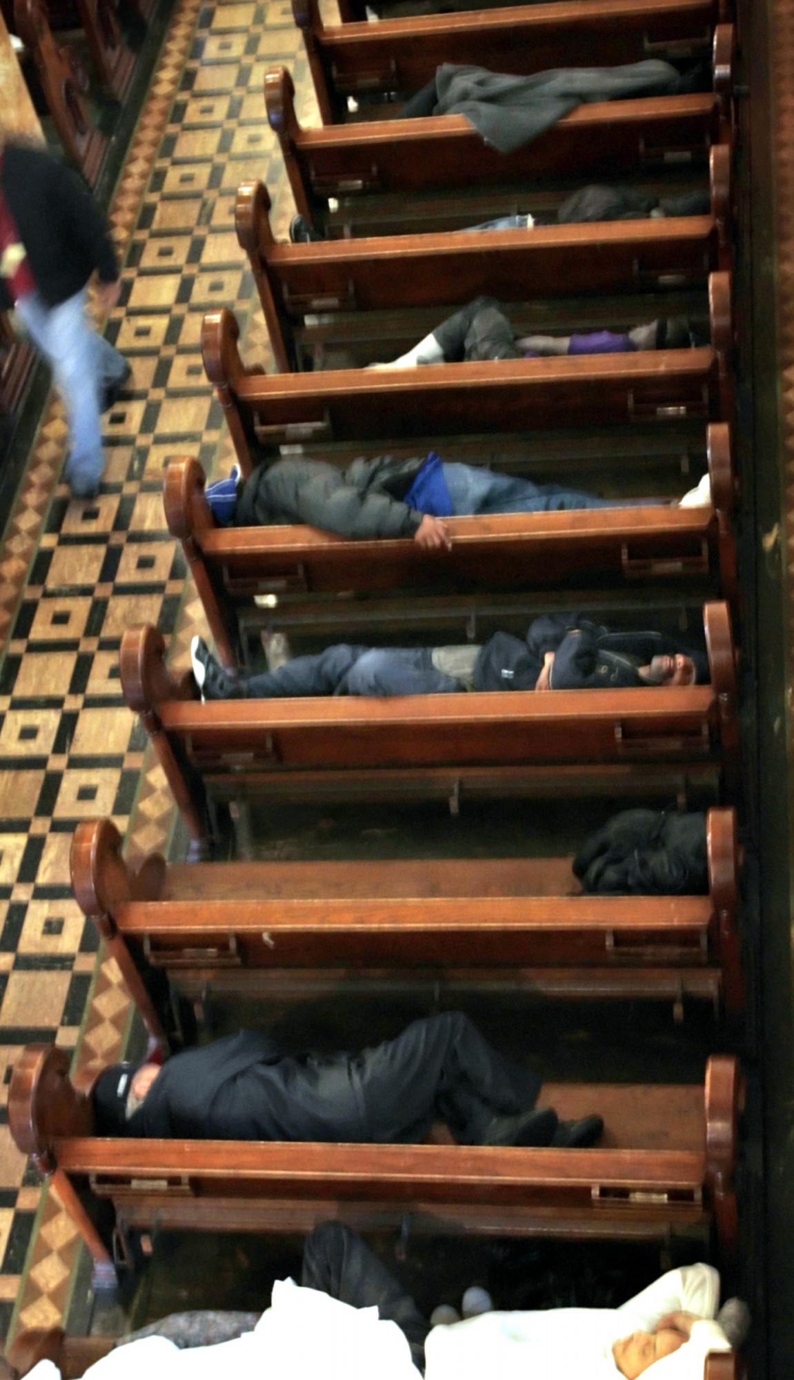 Homeless people sleep on pews at St. Boniface Church in San Francisco on Wednesday, Sept. 14, 2005.  (AP Photo/Ben Margot)