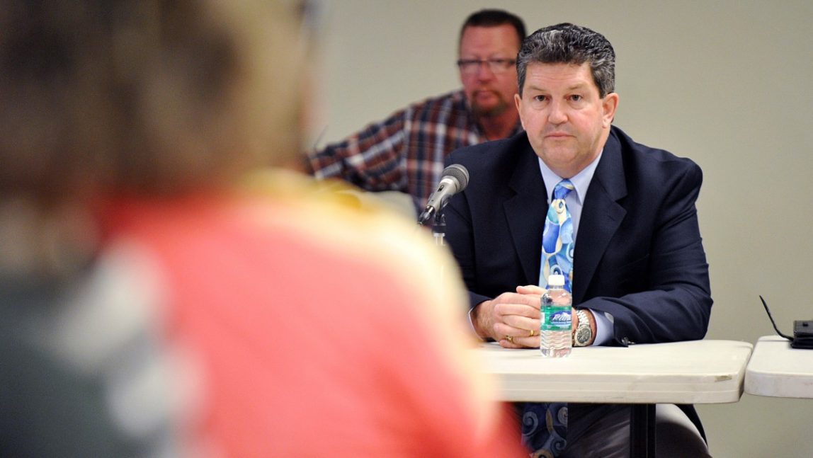 Postmaster General Patrick Donahoe listens to questions on Thursday, April 12, 2012, in the Helena Regional Airport in Helena, Mont., about the direction of the U.S. Postal Service. (AP Photo/The Independent Record, Dylan Brown)