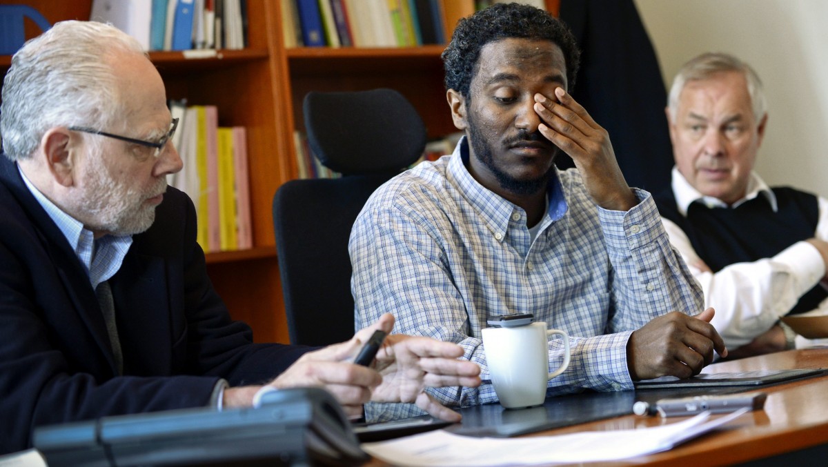 Yonas Fikre, center, a Portland, Oregon Muslim American talks to media with his U.S. attorney Thomas Nelson, left, and Swedish lawyer Hans Bredberg, right, in Stockholm, Sweden, April 18, 2012. After a 2010 trip to visit family in Khartoum, Sudan, Fikre claims to have been detained and tortured. Put on a FBI no-fly list, Fikre is now unable to return home to the U.S. (AP Photo / Claudio Bresciani)