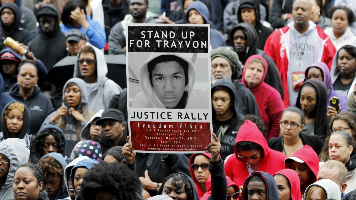People attend a rally demanding justice for Trayvon Martin in Freedom Plaza, Saturday, March 24, 2012, in Washington. Martin, an unarmed young black teen was fatally shot by a volunteer neighborhood watchman. (AP Photo/Haraz N. Ghanbari)