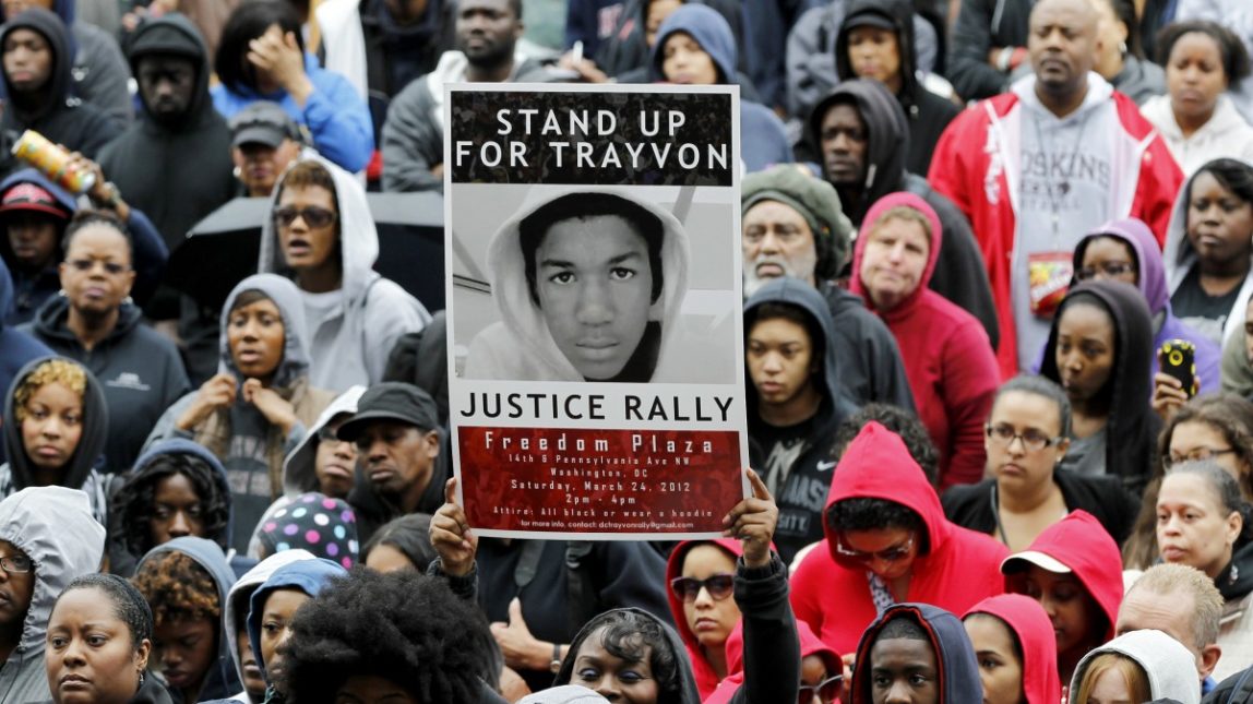 People attend a rally demanding justice for Trayvon Martin in Freedom Plaza on March 24, 2012, in Washington. Martin, an unarmed young black teen was fatally shot by a volunteer neighborhood watchman. (AP Photo/Haraz N. Ghanbari)
