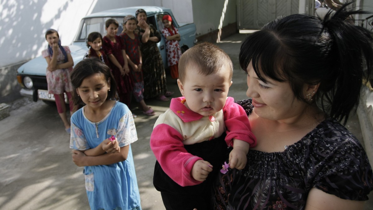 In this May 18, 2009 file photo, an Uzbek woman and children walk in the street of the eastern Uzbek city of Ferghana. According to rights groups, victims and health officials, hundreds of Uzbek women have been surgically sterilized without their knowledge or consent in a program designed to prevent overpopulation from fueling unrest. (AP Photo, file)