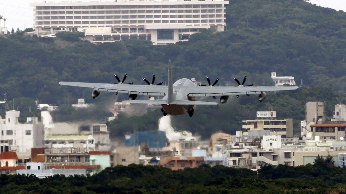 In this Dec. 17, 2009 file photo, a military transport plane takes off from Marine Corps Air Station Futenma in Ginowan, Okinawa, Japan. About 9,000 U.S. Marines stationed on the Japanese island of Okinawa will be moved to the U.S. territory of Guam and other locations in the Asia-Pacific, including Hawaii, under a U.S.-Japan agreement announced Thursday, April 26, 2012. (AP Photo/Shizuo Kambayashi, File)