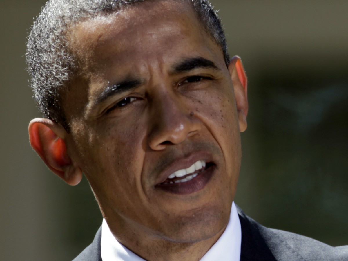 President Barack Obama gestures during his joint news conference with Canadian Prime Minister Stephen Harper, and Mexican President Felipe Calderon, Monday, April 2, 2012, in the Rose Garden at the White House in Washington. (AP Photo/Carolyn Kaster)