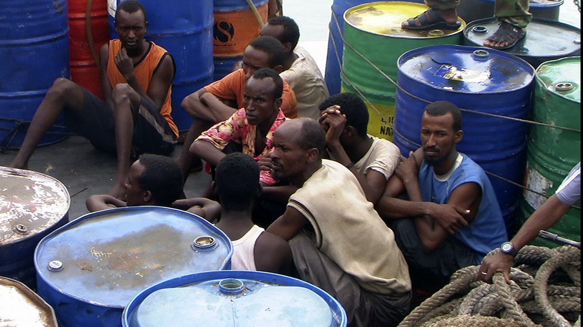Somali pirates held by Puntland police forces, sit in Bassaso, Somalia, Friday, Nov. 21, 2008. Ministers of Puntland state, a self-declared autonomous area, told journalists that they have many Somali pirates in their detention centers. A multinational effort is being mobilized to provide security in the area to fight the pirates off Somalia which culminated in EU airstrikes against targets on Tuesday. (AP Photo)