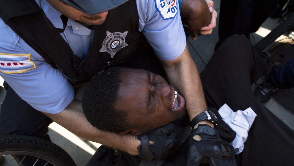 A NATO protestor is arrested after refusing to let go of a police bicycle, Saturday, May 19, 2012, in Chicago. Security has been high throughout the city in preparation for the NATO summit, where delegations from about 60 countries will discuss the war in Afghanistan and European missile defense. (AP Photo/John Minchillo)