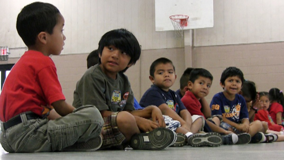 In this Aug. 17, 2011 file photo, students sit in the gym at Crossville Elmentary School in Crossville, Ala. Despite being in an almost all-white town, the school's enrollment is about 65 percent Hispanic. Hispanic students have started vanishing from Alabama public schools in the wake of a court ruling that upheld the state's tough new law cracking down on illegal immigration. Education officials say scores of immigrant families have withdrawn their children from classes or kept them home this week, afraid that sending the kids to school would draw attention from authorities. There are no precise statewide numbers. But several districts with large immigrant enrollments â from small towns to large urban districts â reported a sudden exodus of children of Hispanic parents, some of whom told officials they would leave the state to avoid trouble with the law, which requires schools to check students' immigration status. (AP Photo/Jay Reeves, File)