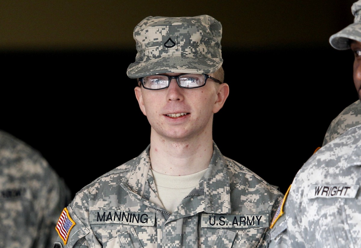 In this file photo taken Dec. 22, 2011, Army Pfc. Bradley Manning is escorted from a courthouse in Fort Meade, Md. An Army officer has ordered a court-martial, Friday, Feb. 3, 2012 for Manning, a low-ranking intelligence analyst charged in the biggest leak of classified information in U.S. history. (AP Photo/Patrick Semansky, File)
