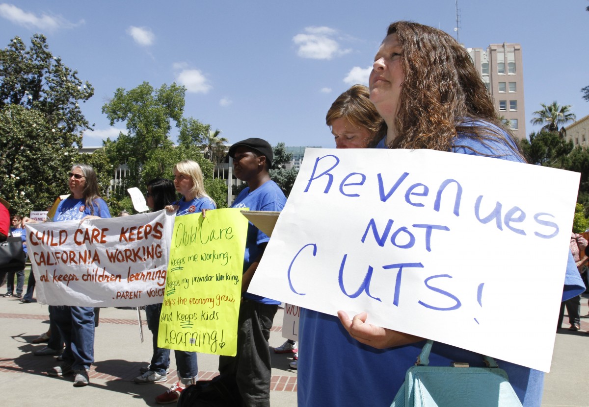 Jennifer Greppi, right, , joined others in a demonstration against further state budget cuts to social services at the Capitol in Sacramento, Calif., Monday, May 14, 2012. Gov. Jerry Brown unveiled his revised state budget plan, Monday, that includes an additional $8 billion in cuts to cover a $15.7 billion budget shortfall for the fiscal year that starts July 1.(AP Photo/Rich Pedroncelli)