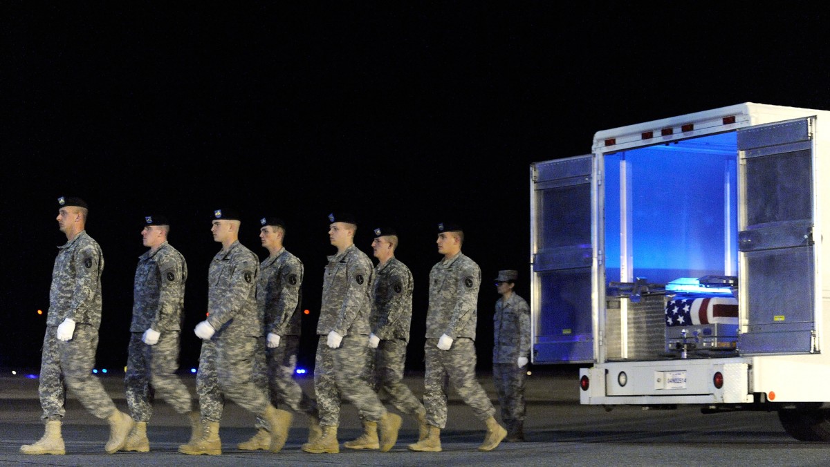 An Army carry team marches away from a transfer case containing the remains of Staff Sgt. Dick A. Lee Jr. Sunday, April 29, 2012 at Dover Air Force Base, Del. According to the Department of Defense, Lee, 31, of Orange Park, Fla., died April 26, 2012 in Ghazni province, Afghanistan from injuries sustained when his vehicle encountered an improvised explosive device. (AP Photo/Steve Ruark)