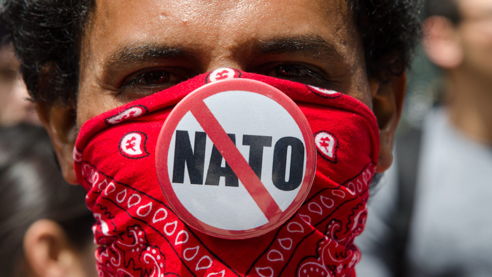 A demonstrator shows his opposition to NATO during a peaceful protest on the last day of the summit in Chicago Monday, May 21, 2012. (Photo by Norbert Schiller/Mint Press)