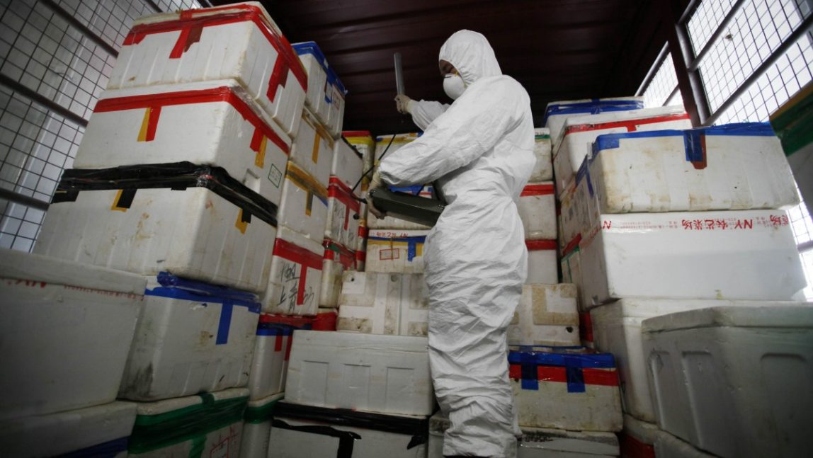 A staff member from Food and Environmental Hygiene Department wearing a protective suit, scans a boxes April 27, 2012. Recently, more than 1,300 tubes carrying radioactive water in California were reported damaged, keeping a coastal plant closed for 3 months. (AP Photo/Kin Cheung, Pool)