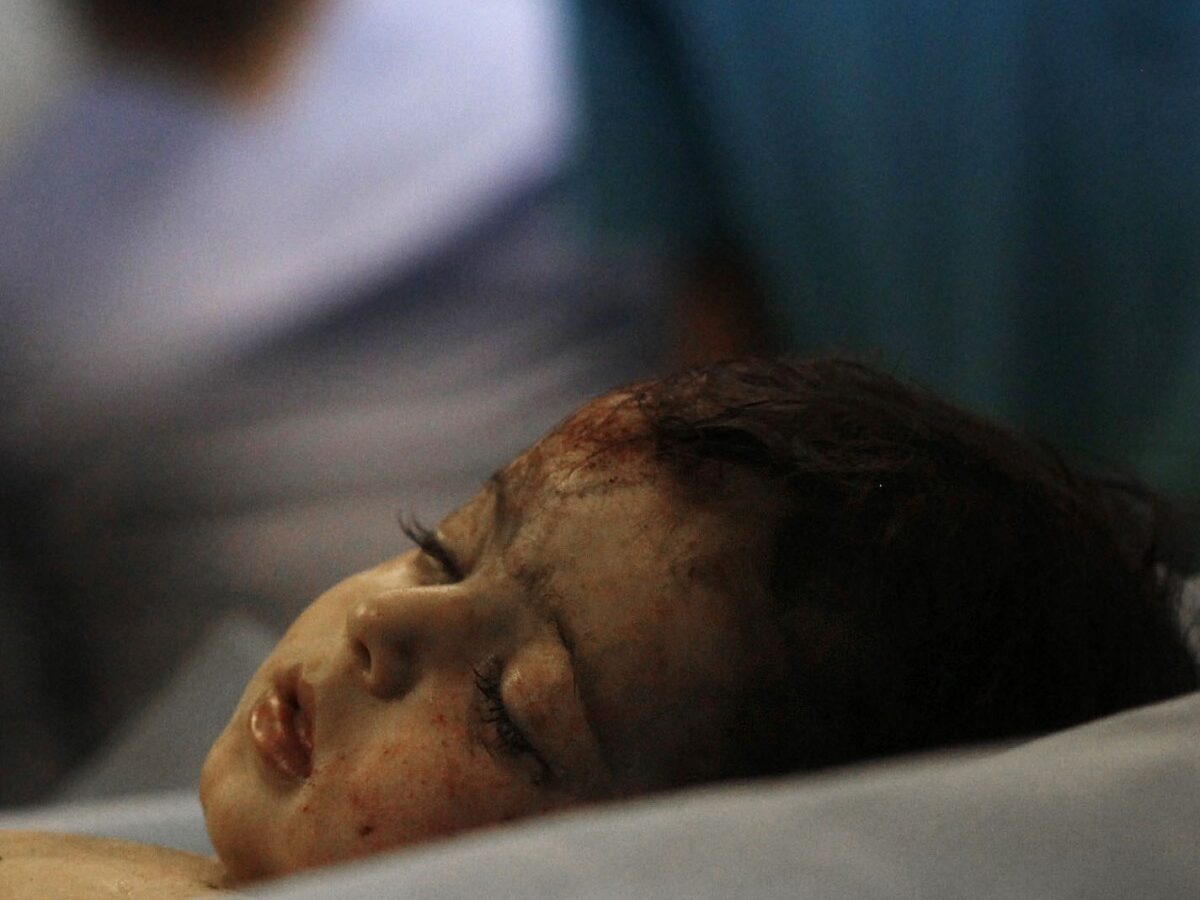 In a June 19, 2011, file photo made on a government-organized tour, shows a body of a girl who was found in the damaged residential building in Tripoli's outskirts at a hospital in Libya. Human Rights Watch is calling on NATO to provide compensation for Libyans who lost loved ones or had property damaged in airstrikes during the bombing campaign that helped rebels oust former leader Moammar Gadhafi. (AP Photo/Ivan Sekretarev, File)