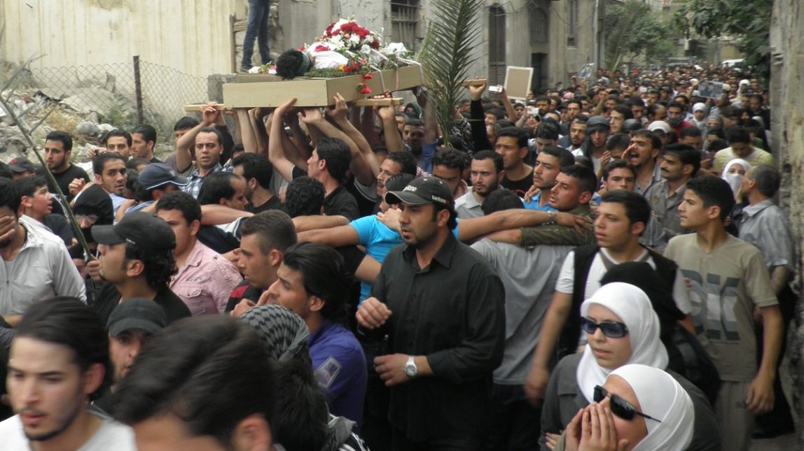 Anti-Syrian regime mourners shout slogans and carry the body of activist Nour al-Zahraa, 23, who was shot by Syrian security forces on Sunday, during his funeral procession, in the Kfar Suseh area, in Damascus, Syria, on Monday, April 30, 2012. (AP Photo)