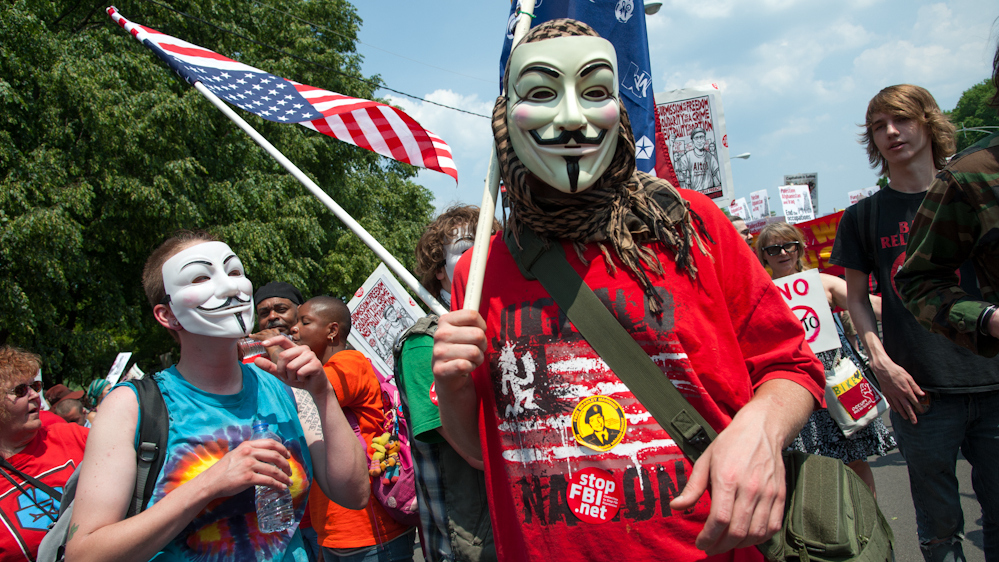 Demonstrators wearing Guy Fawkes masks walked through Chicago Sunday, May 21. (Photo Norbert Schiller/Mint Press)