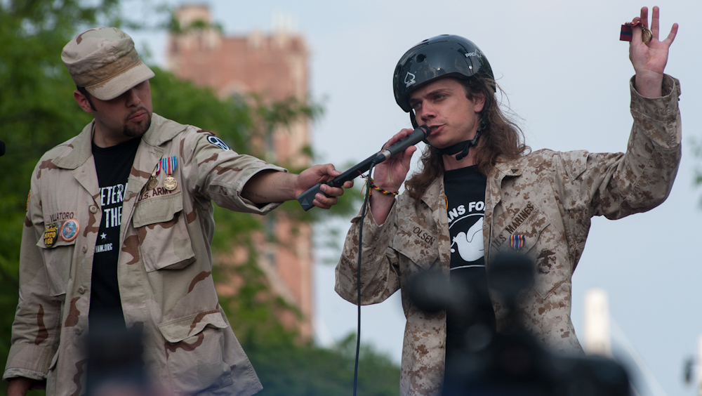 One veteran stands, ready to throw a war medal. Veterans protested war by giving their medals from the wars in Afghanistan and Iraq back. (Photo Norbert Schiller/Mint Press)