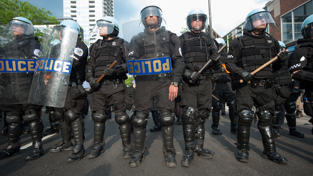 Police stand ready near the end of a protest march May 20, 2012. (Photo Norbert Schiller/Mint Press)
