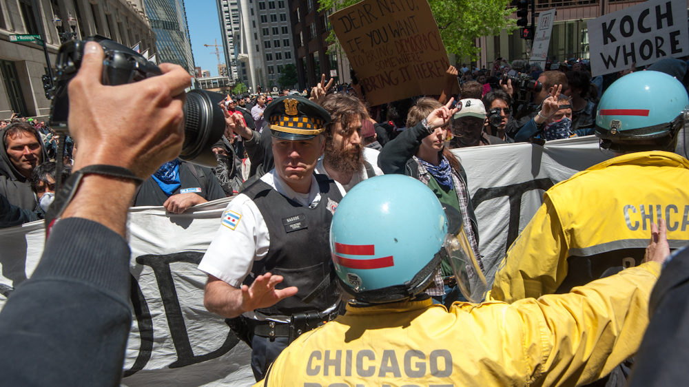 Captain Nagode of the Chicago Police Department coordinating with demonstrators as they stage a peaceful march through Chicago's financial district protesting the NATO Summit taking place in the city on Monday May 21, 2012. (Photo Norbert Schiller/Mint Press)