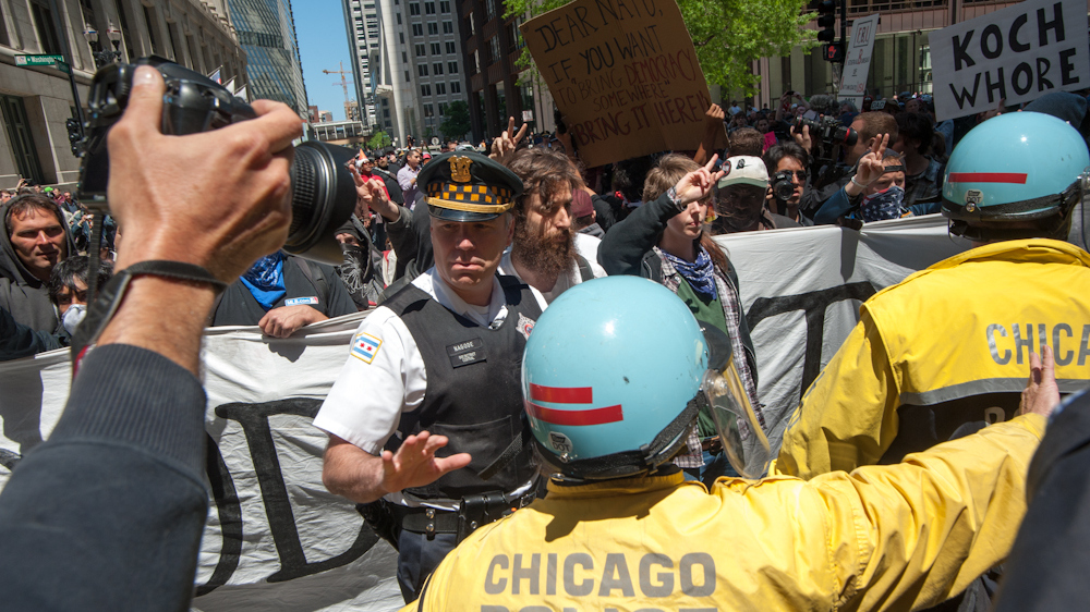 Captain Nagode of the Chicago Police Department coordinating with demonstrators as they stage a peaceful march through Chicago's financial district protesting the NATO Summit taking place in the city on Monday May 21, 2012. (Photo Norbert Schiller/Mint Press)